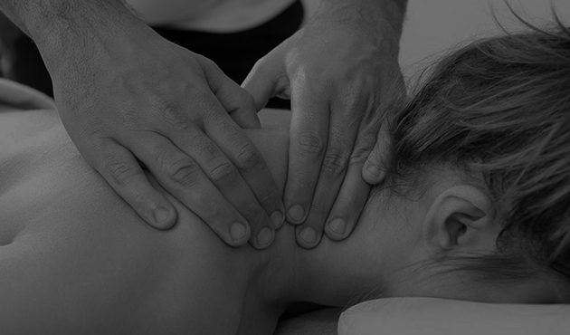 Deep tissue massage across the upper back